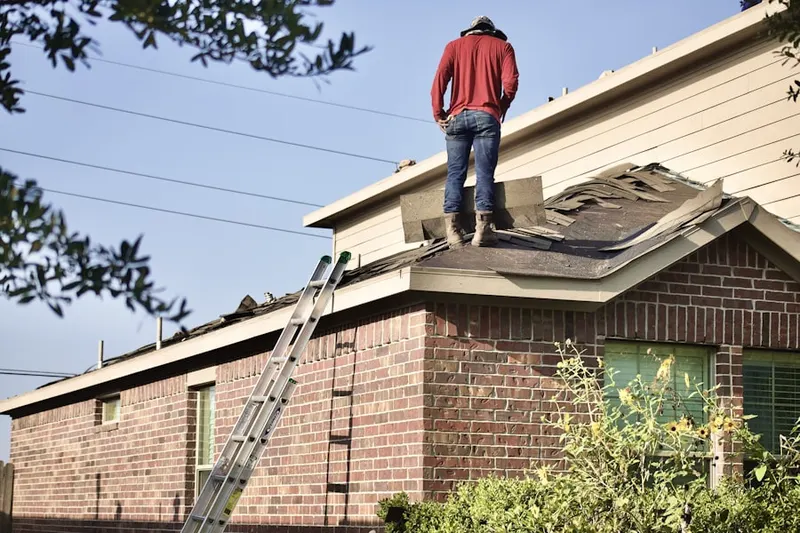 Professional roofer working on a residential roof in Wright